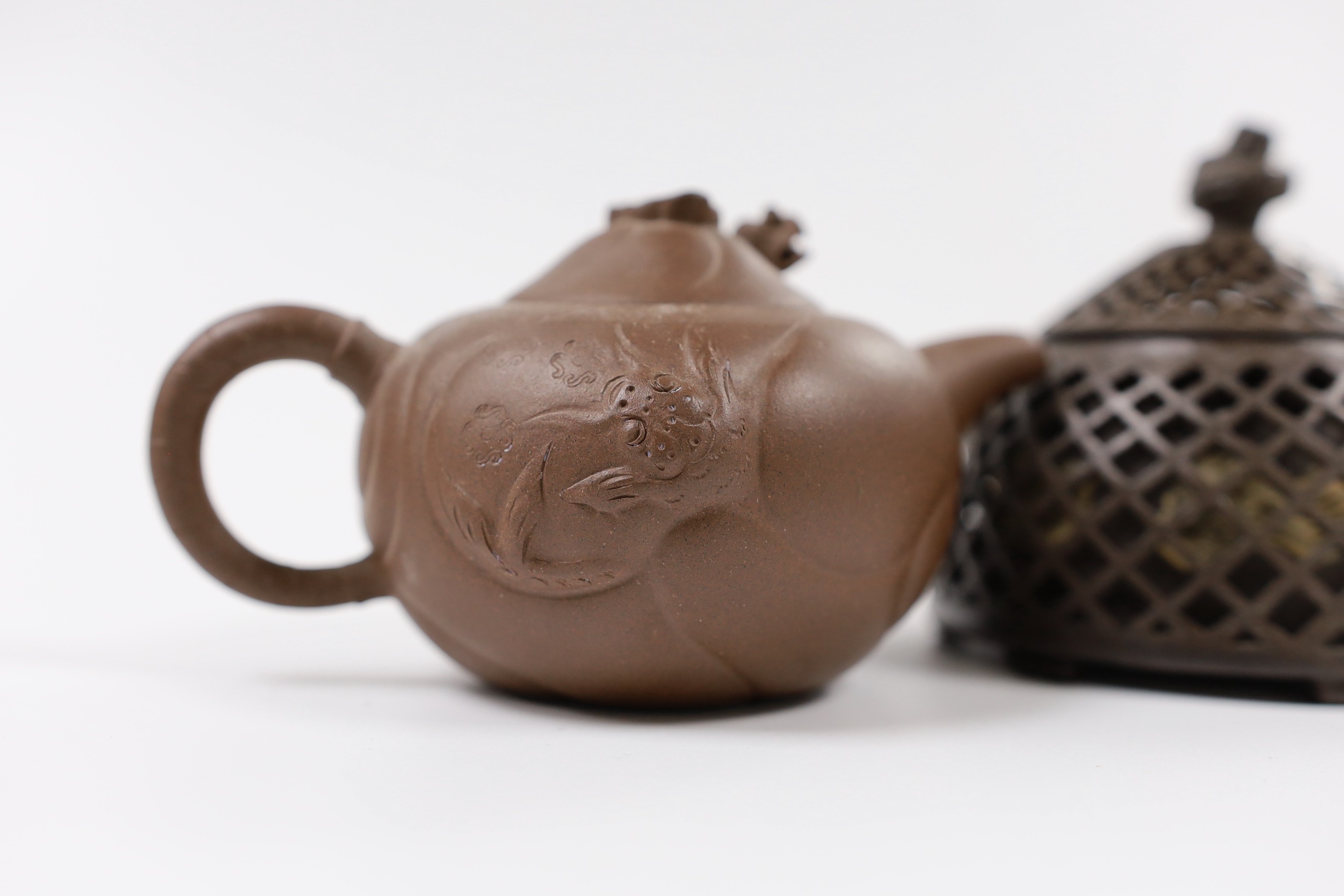 A Chinese Yixing reticulated teapot and cover and another